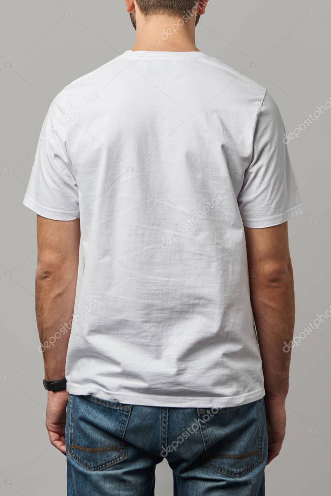 Back view of man in white t-shirt with copy space isolated on grey