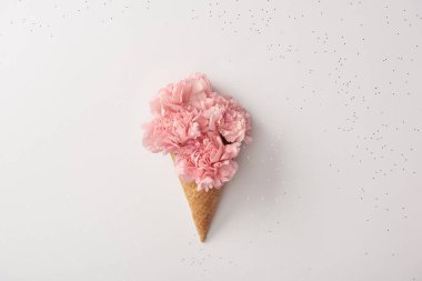 beautiful pink carnation flowers in waffle cone isolated on grey clipart