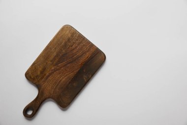 top view of wooden cutting board on grey background clipart