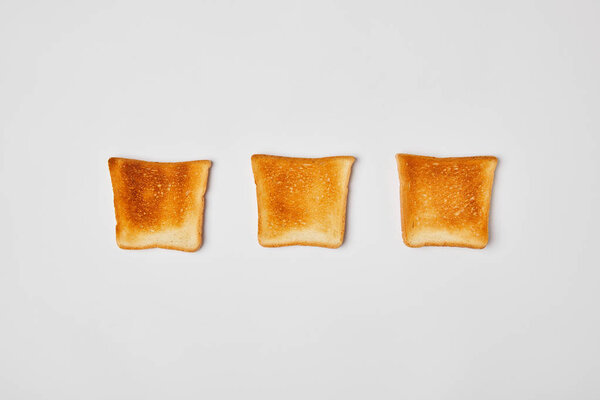 top view of grilled crispy toasts on grey background