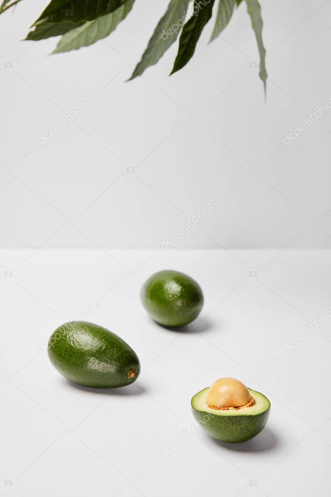 selective focus of avocados on grey background