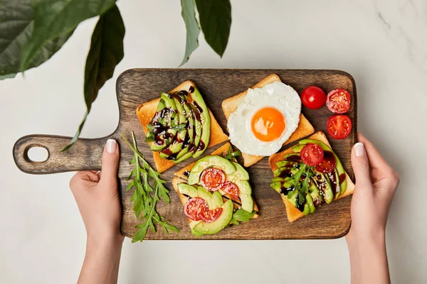 Top View Womans Hands Holding Wooden Cutting Board Toasts Scrambled — Stock Photo, Image