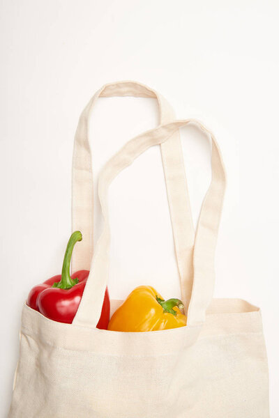 Studio shot of bell peppers in eco bag on white background