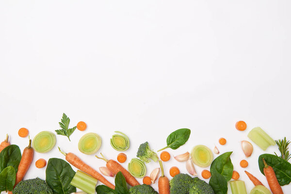 Top view of fresh vegetables on white background