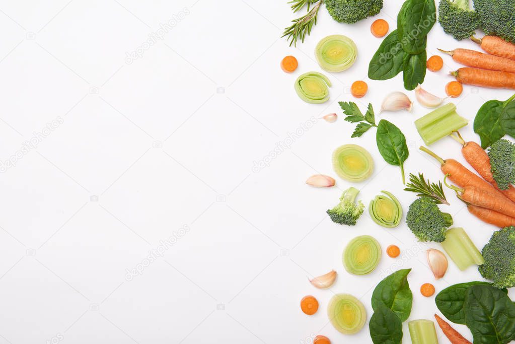 Flat lay with natural vegetables and spinach leaves isolated on white