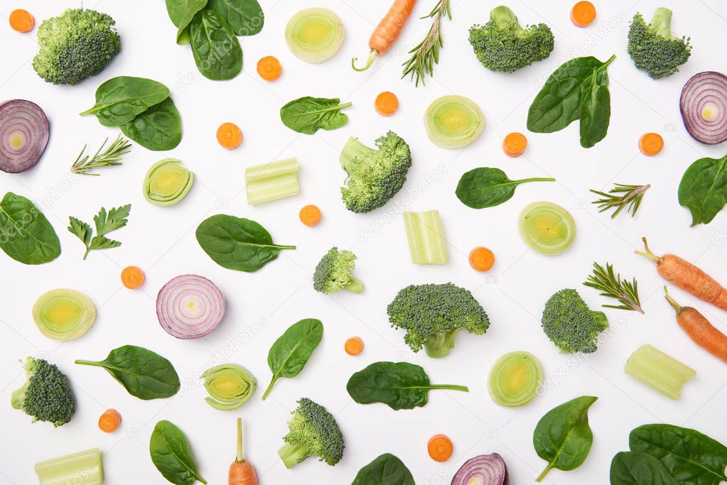Flat lay with cut vegetables on white background
