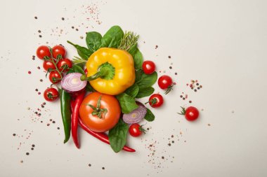 Top view of fresh vegetables and spices on grey background clipart