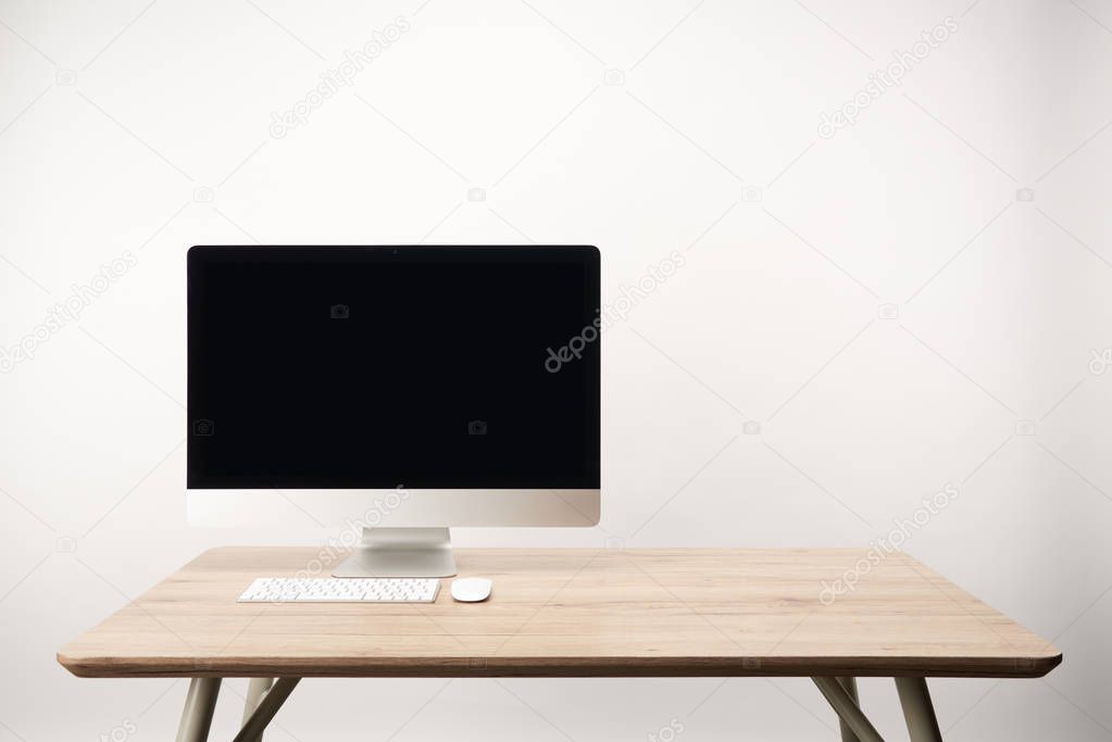 workplace with desktop computer on wooden table isolated on white with copy space