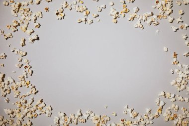 top view of tasty and salty popcorn lying isolated on white  clipart