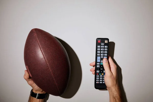Cropped View Man Holding Remote Control Brown Ball White Background — Stock Photo, Image