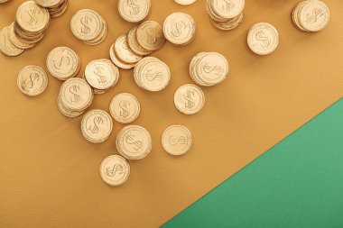 top view of golden coins with dollar signs on green and orange background, st patrick day concept clipart
