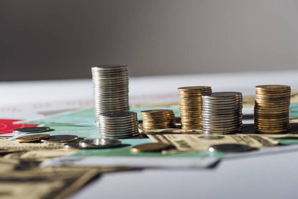 selective focus of stacks on dollar and euro banknotes with grey blurred background