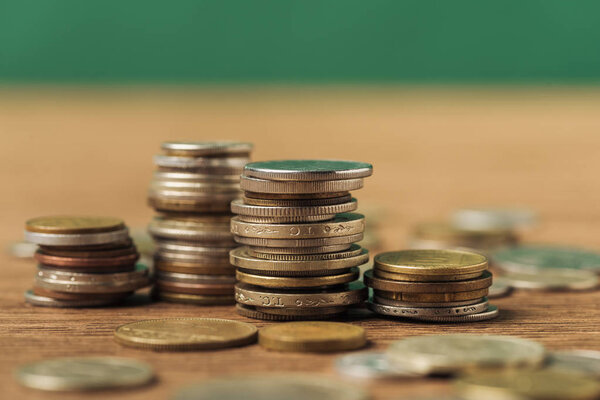 selective focus of coins stacks on wooden blurred background