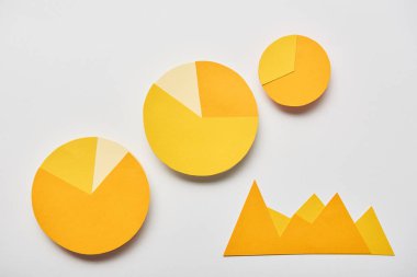 top view of paper yellow charts and graphs on white background clipart