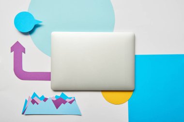 Kağıt grafikler ile kapalı dizüstü işaretçi beyaz arka plan üzerinde üstten görünüm