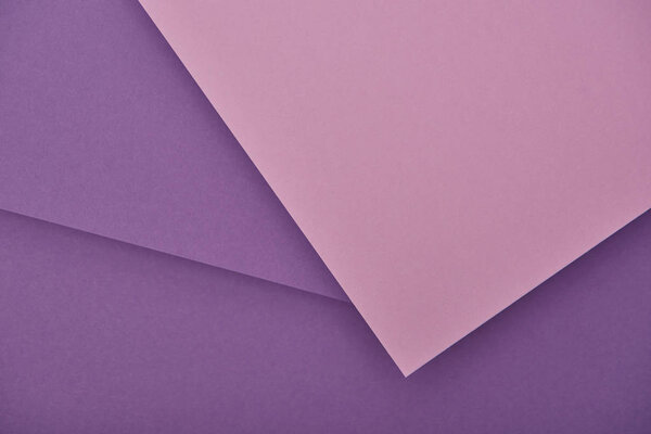 top view of lilac and violet laid out paper sheets with copy space