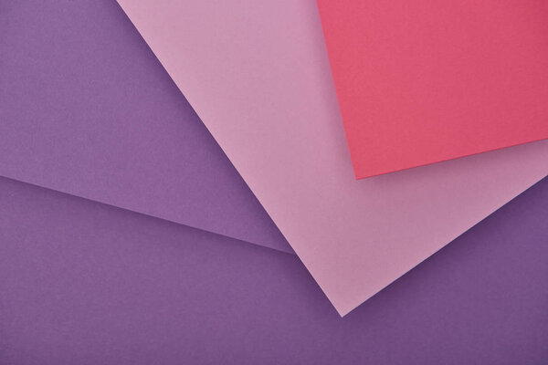 top view of lilac, violet and pink paper sheets with copy space