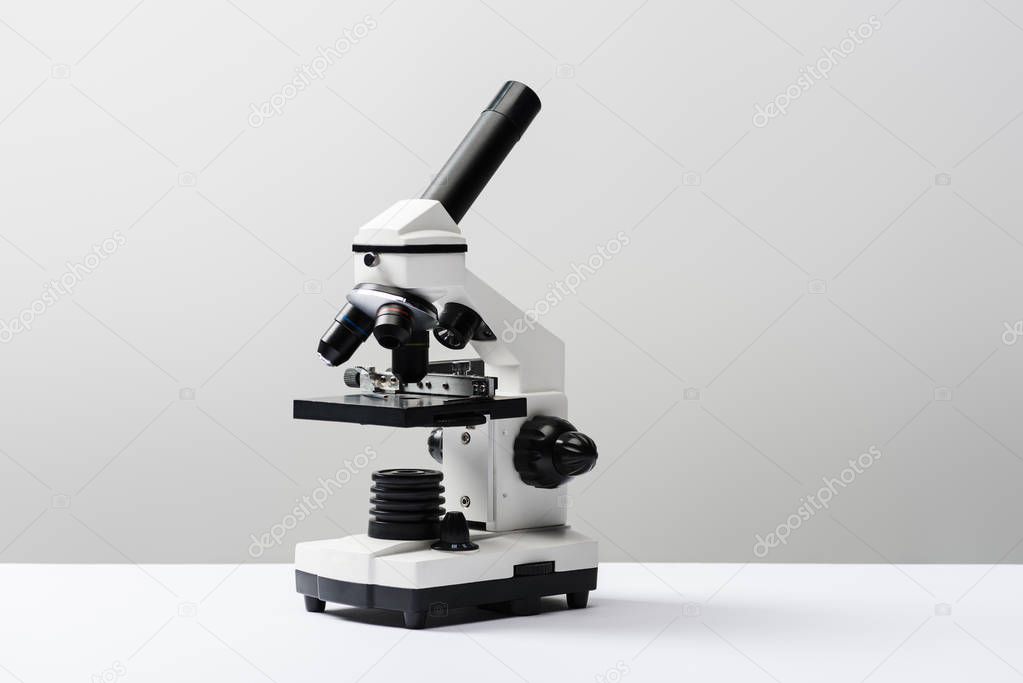 microscope on grey background with copy space