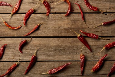 top view of red hot chili peppers on wooden background clipart