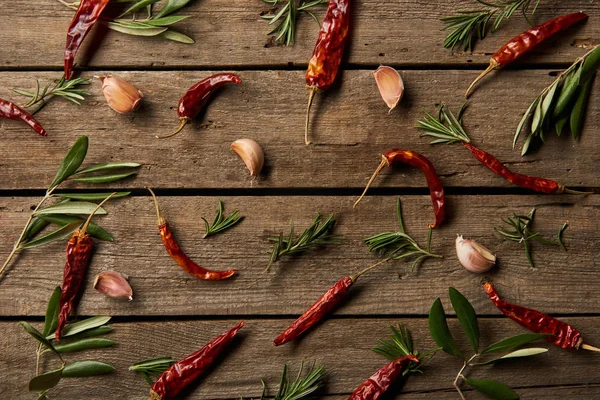 Top view of chili peppers, rosemary branches and garlic cloves on wooden background — Stock Image Top View Chili Peppers Rosemary Branches Garlic Cloves Wooden Background Stock Image