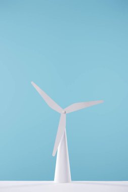 white windmill model on table and blue background clipart