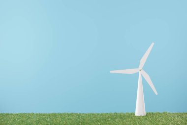 windmill model on green grass and blue background    clipart