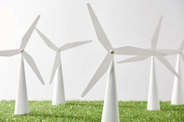 windmill models on green grass and white background clipart