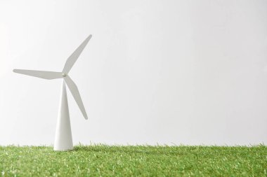 windmill model on green grass and white background with copy space clipart