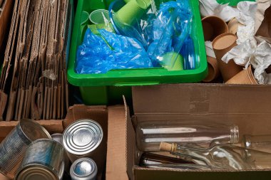 sorted trash of cardboard, glass and plastic bottles, polyethylene, cups, paper, iron cans