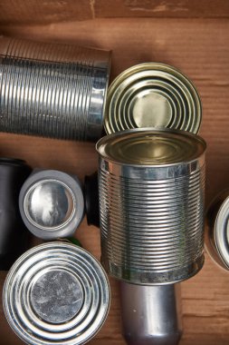 different iron silver cans in cardboard box clipart