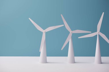 windmill models on white table and blue background clipart