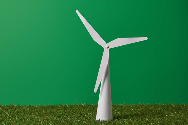 white windmill model on green grass and background   