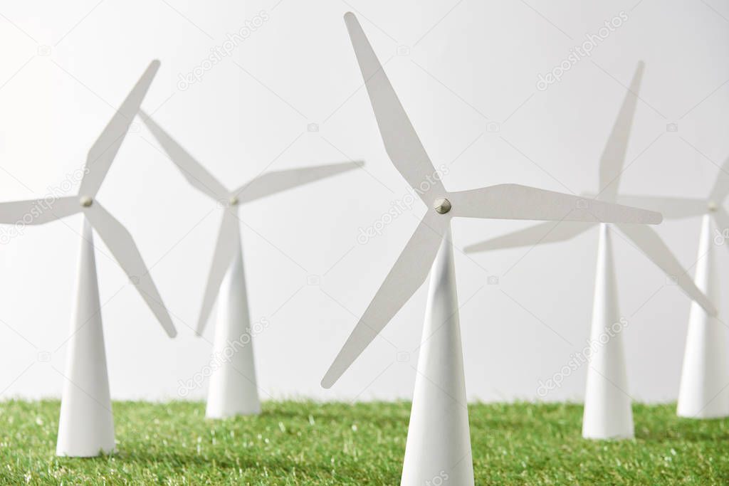 windmill models on green grass and white background
