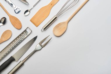 flat lay with metal and wooden cooking utensils on grey background  clipart