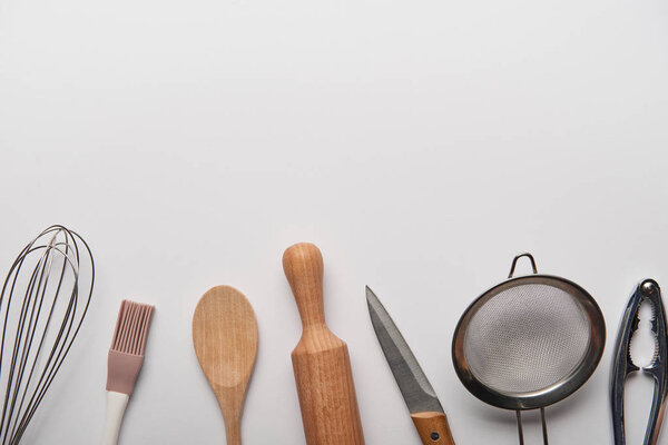 top view of cooking utensils on grey background 