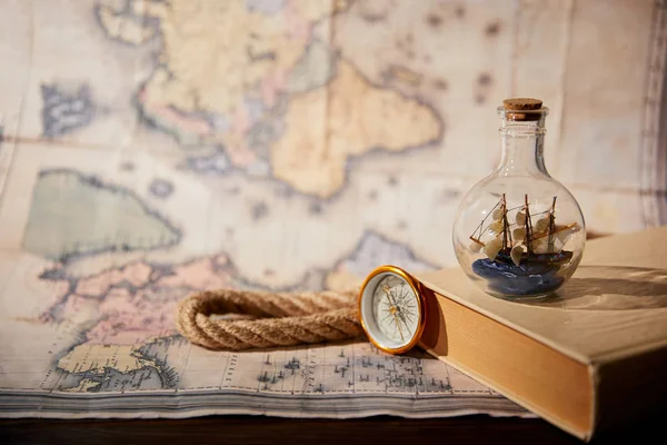Selective Focus Toy Ship Glass Bottle Book Map Compass Rope — Stock Photo, Image