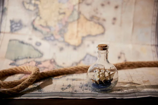 Rope Toy Ship Glass Bottle Map Wooden Table — Stock Photo, Image