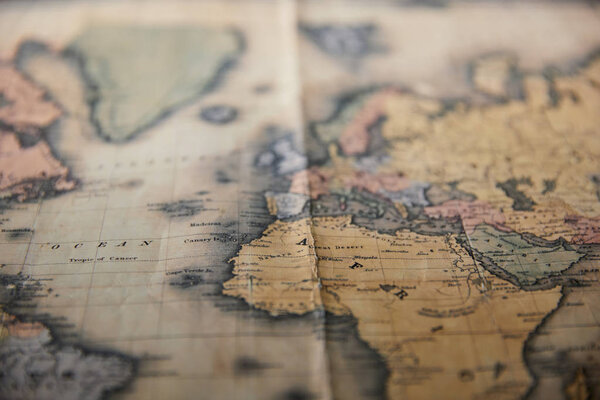 Selective focus of world retro map on table