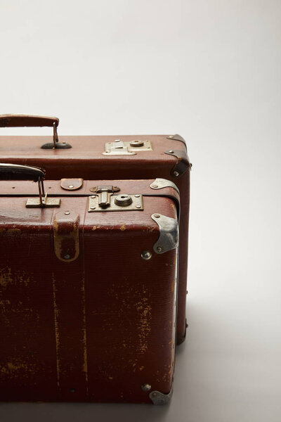 brown suitcases with copy space on grey background 