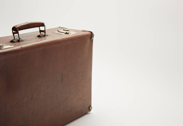 vintage brown suitcase on grey background with copy space