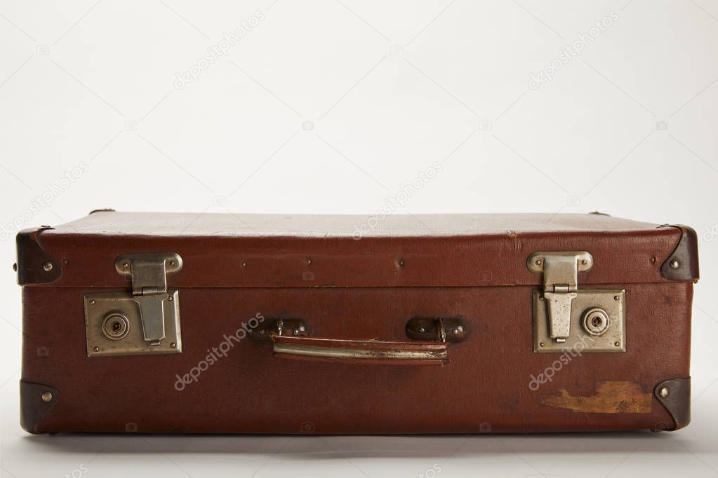 vintage brown suitcase on grey background with copy space