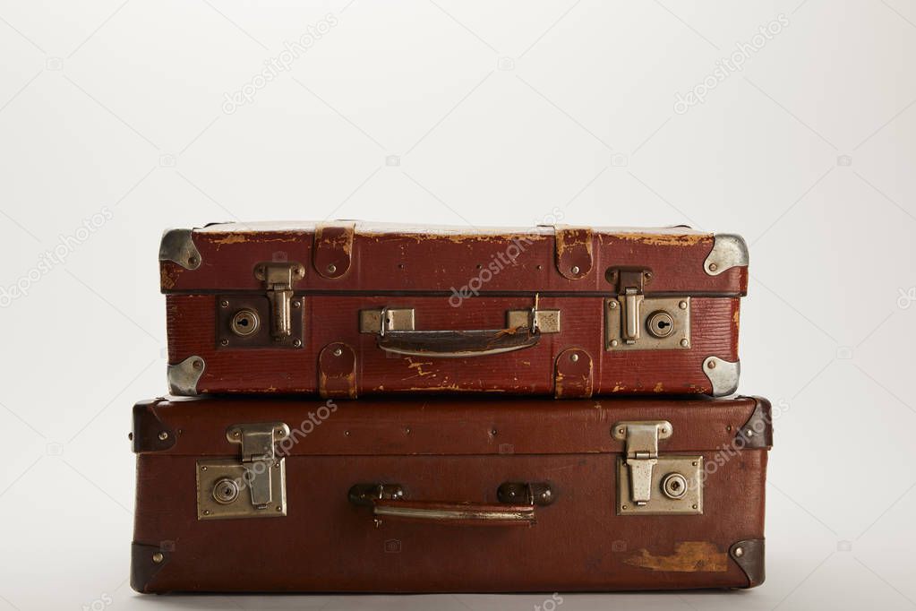 vintage brown suitcases on grey background with copy space 
