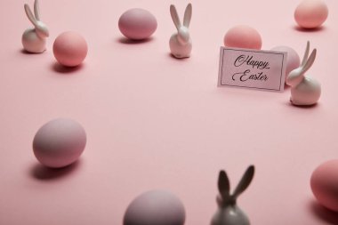 kopya alanı ile pembe arka plan üzerinde mutlu Paskalya yazı ve Paskalya kartı oyuncak tavşanlar, yumurta 