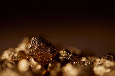 selective focus of golden stones with blurred and black background clipart