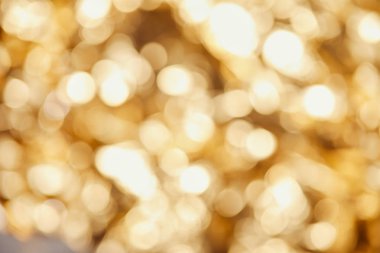 bright blurred twinkles and sparkles on golden background