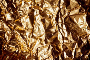 crumpled golden foil with shadows and twinkles clipart