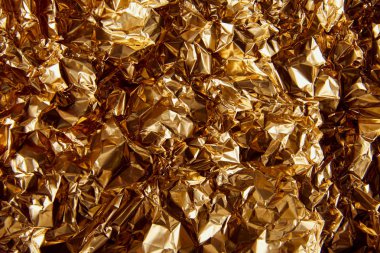 top view of crumpled golden foil with glares clipart