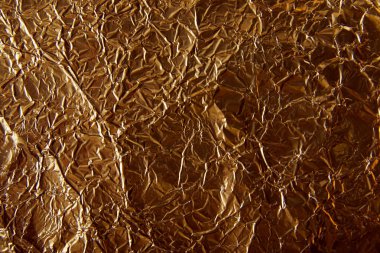 top view of rumpled sheet golden foil in shadow clipart
