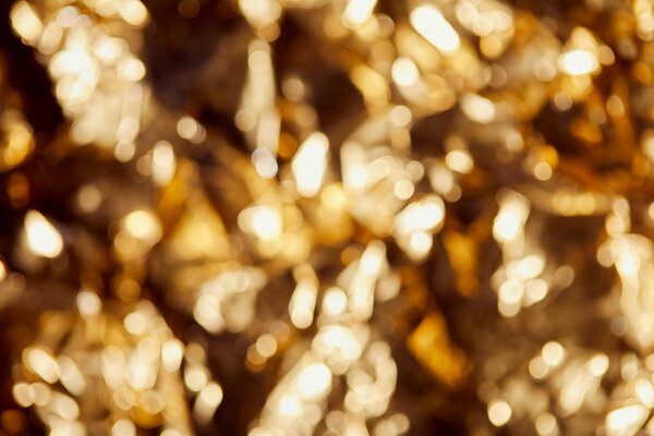 bright blurred twinkles and sparkles on golden background