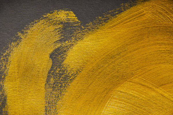 golden brushstrokes drawn on grey textured background